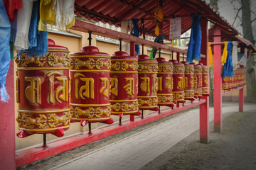 Fototapeta na wymiar Prayer wheels at the yard of Datsan Gunzechoinei.