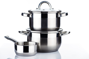 close-up view of shiny stainless steel pots and pans on white - Powered by Adobe