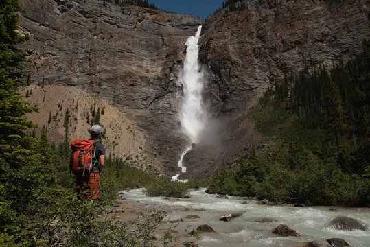 Female hiker looking at waterfall