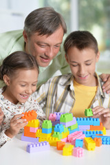 Obraz premium Portrait of father and children playing at home