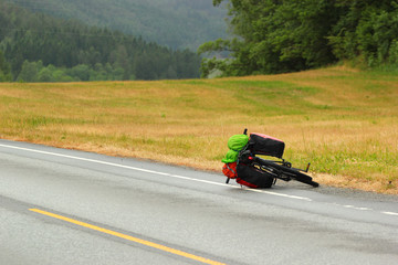 Bicycle with touring bags lying on a roadside