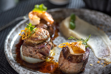 Grilled steak meat with foie gras, shrimp, cheese and glass of red wine © PTK