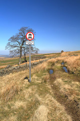 Moorland track with road sign