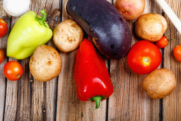 Homemade rustic vegetables on an old wooden table.