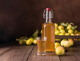 Cocktail of ripe fresh apples in a glass on a wooden background. Apple cider, wine.