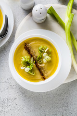vegetable cream soup from vegetables, served on a table with olive oil. healthy kitchen