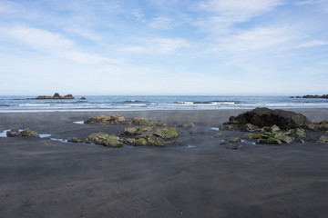 Schwarzer Sandstrand mit Felsen - Halbinsel bei Djúpivogur / Ostfjorde - Island