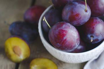 fresh plums on wooden table