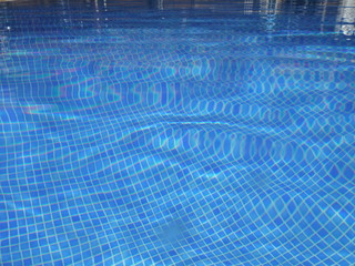 Distorted Blue Tile Texture under the Water in a Swimming Pool