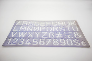 Light blue alphabet stencil lettering PVC plastic ruler template isolated on white