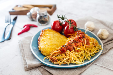 Escalope of spaghetti with tomatoes sauce and basil