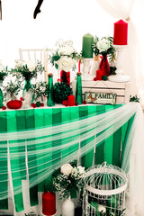Soccer and pole sport dancer wedding decor in Eco rustic style with green ribbons, red candles, bottles, white flowers and green leaves.