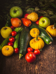 Autumn vegetables on a wooden table. Low key lighting