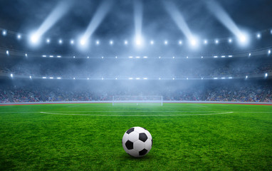 Fototapeta na wymiar Ball on gras in soccer stadium