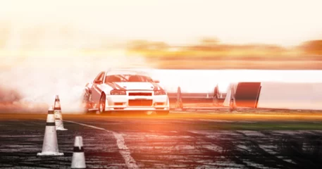 Zelfklevend Fotobehang Blurred image of car drifting on track with grain, Sport car wheel drifting and smoking on track. © applezoomzoom