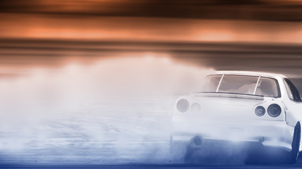 Blurred image of car drifting on track with grain, Sport car wheel drifting and smoking on track. - obrazy, fototapety, plakaty