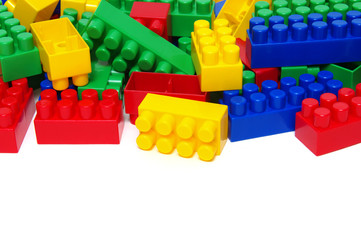 Fototapeta premium Plastic building blocks on white