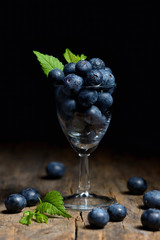 Blueberries with leaves on wooden table