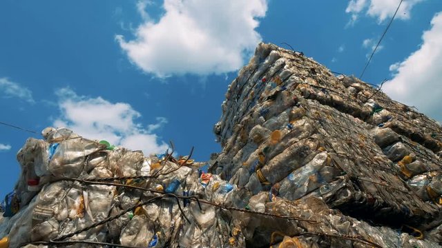 View of a landfill on a sky background. Rubbish in huge stacks lay on a dump.
