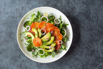 Avocado and Blood Orange Salad with Fennel and Purple Onions Over Mixed Greens on Plate
