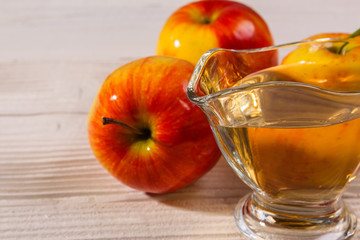 apple vinegar on a wooden rustic background
