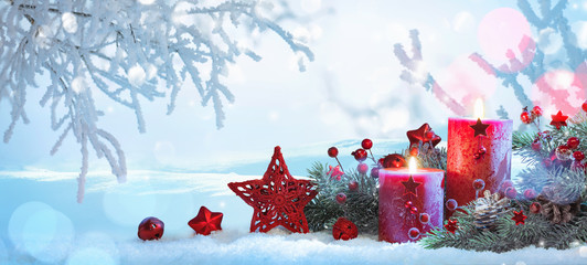Christmas Decorations With Candles On a Snowy Background