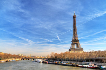 Beautiful Eiffel tower at the Seine river with a dramatic sky in winter