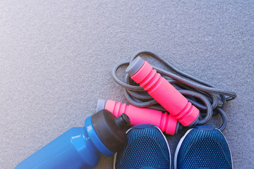 Jump rope, Running shoes, and drink bottle on the ground