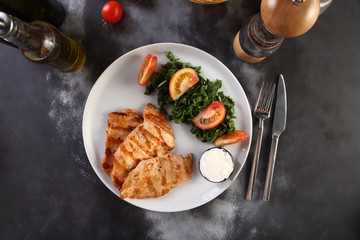 chicken grill with vegetables on a wooden background
