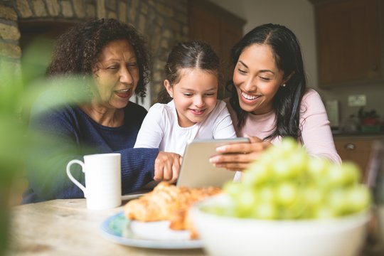 Family Using Digital Tablet At Home