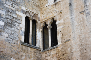 Fototapeta na wymiar Italy, Gioia del Colle, Norman-Swabian Castle, 9th century. View of the internal facades of the court. Detail of windows.