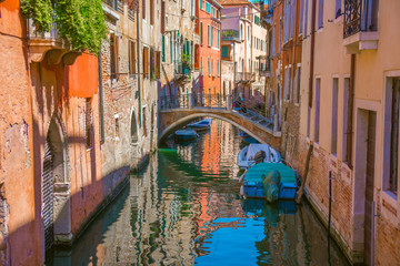 boats in narrow canals in Venice, Italy