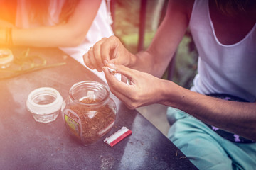 Young couple coffee and tea tasting during sunset in the jungle rainforest of a tropical Bali island.