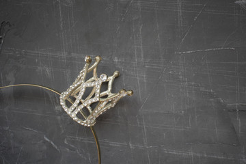 silver crown on a concrete background, place for inscription and advertising, copy space