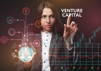 The concept of business, technology, the Internet and the network. A young entrepreneur working on a virtual screen of the future and sees the inscription: Venture capital