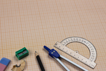 A close-up photo of stationary set: pen, pencil, compass, rubber, protractor, calipers and etc. on...