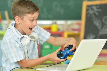 Portrait of boy playing computer game at home © aletia2011