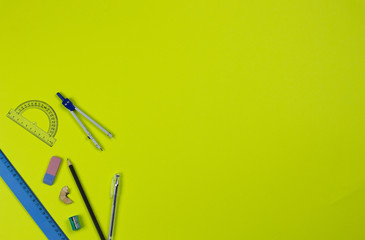 A photo of stationery set: pencil, rubber, sharpener, compass, protractor, ruler, crumpled paper...