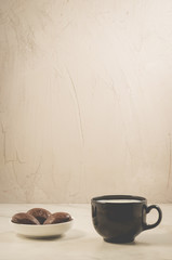 breakfast with chocolate gingerbreads and milk/chocolate gingerbreads and milk in a black mug on a white background. Selective focus