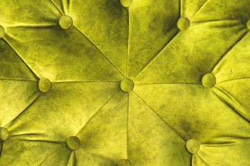 Velor surface of sofa close-up. Training equipment-velor mats tightened with buttons. Yellow chesterfield style quilted upholstery background close up