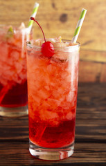 Glass of Cold Refreshing Cherry Limeade on a Wooden Table