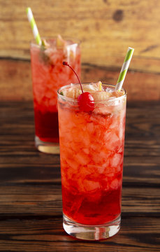 Glass of Cold Refreshing Cherry Limeade on a Wooden Table