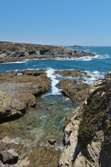 Fototapeta na wymiar Pessegueiro Island, rocks and cliffs in Porto Covo. Alentejo, Portugal