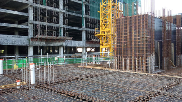 Floor slab and beam reinforcement bar under construction to form reinforcement concrete. Construction workers tied it together using tiny wires.