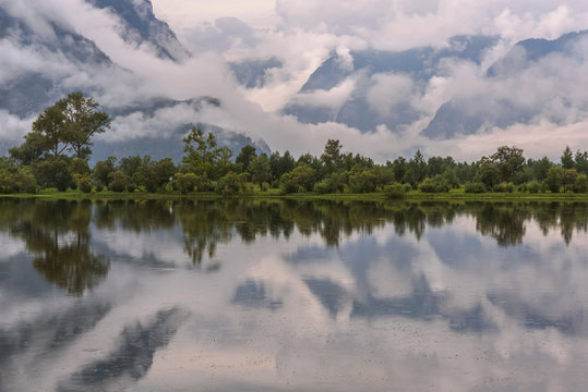 lake clouds fog mountains reflections