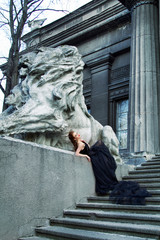 Art work Gothic fashion: a beautiful young girl in black dress and headwear sitting near castle....