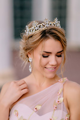 portrait of happy bride against background of columns