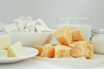 dairy products, milk, cottage cheese, cheese, sour cream, butter on light background