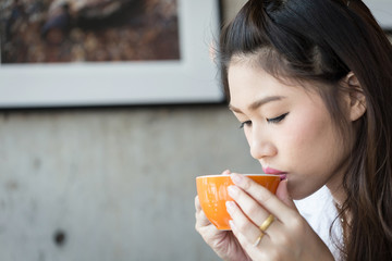 Beautiful Attractive Asian woman drinking coffee feeling so relax and comfortable