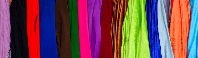 colorful of luxury fabric in the shop - background.